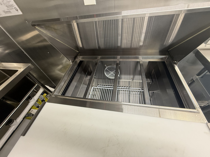 Commercial hood vent and cooking equipment inside 2025 food trailer
