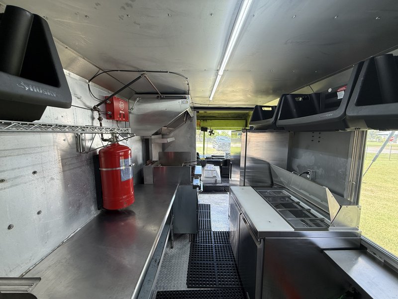 Food truck interior with stainless counters and prep table