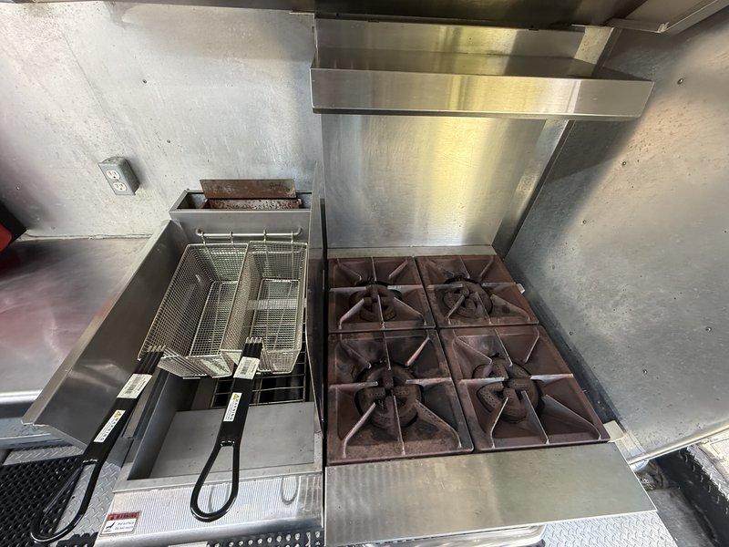 Food truck fryer next to four burner range