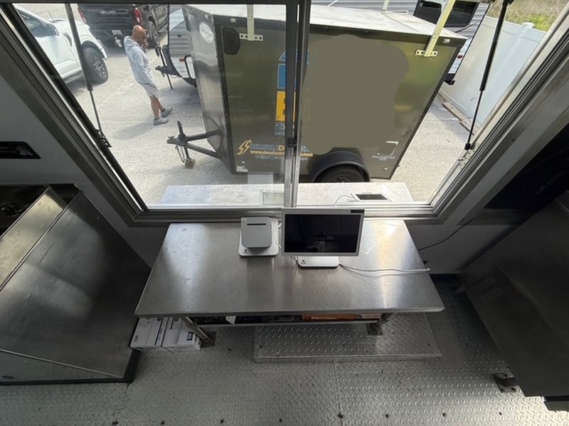 4-foot sliding glass service window with stainless counter and POS system inside a 2022 Ford F59 food truck for sale in Pasco County FL
