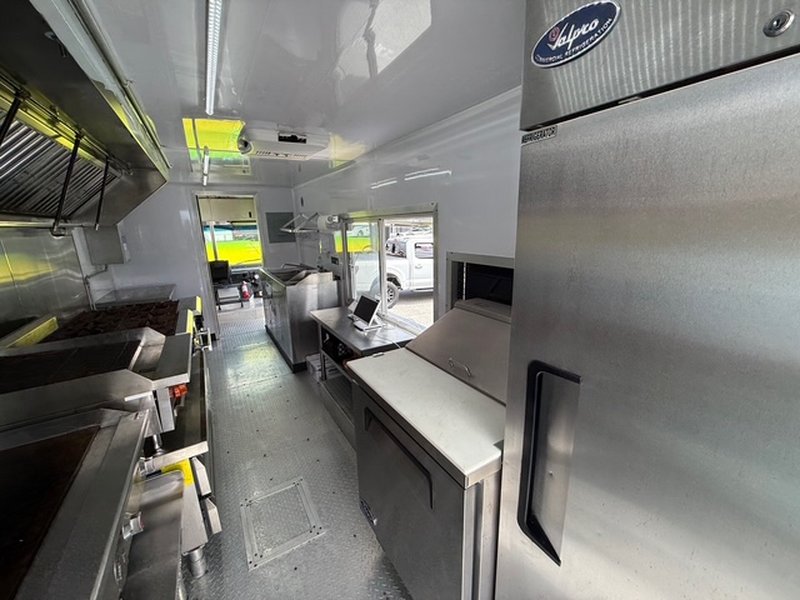 Solpco upright commercial refrigerator and rear kitchen view of a 2022 Ford F59 food truck for sale in Pasco County FL