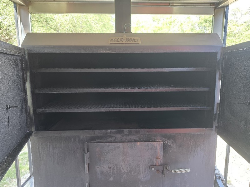 Interior racks inside the built-in smoker of the BBQ trailer